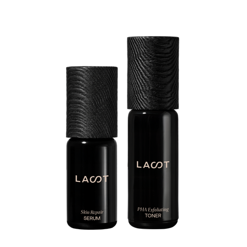 Two violet glass bottles of LAST skincare products (Skin Repair Serum and PHA Exfoliating Toner) on a white backgroundk