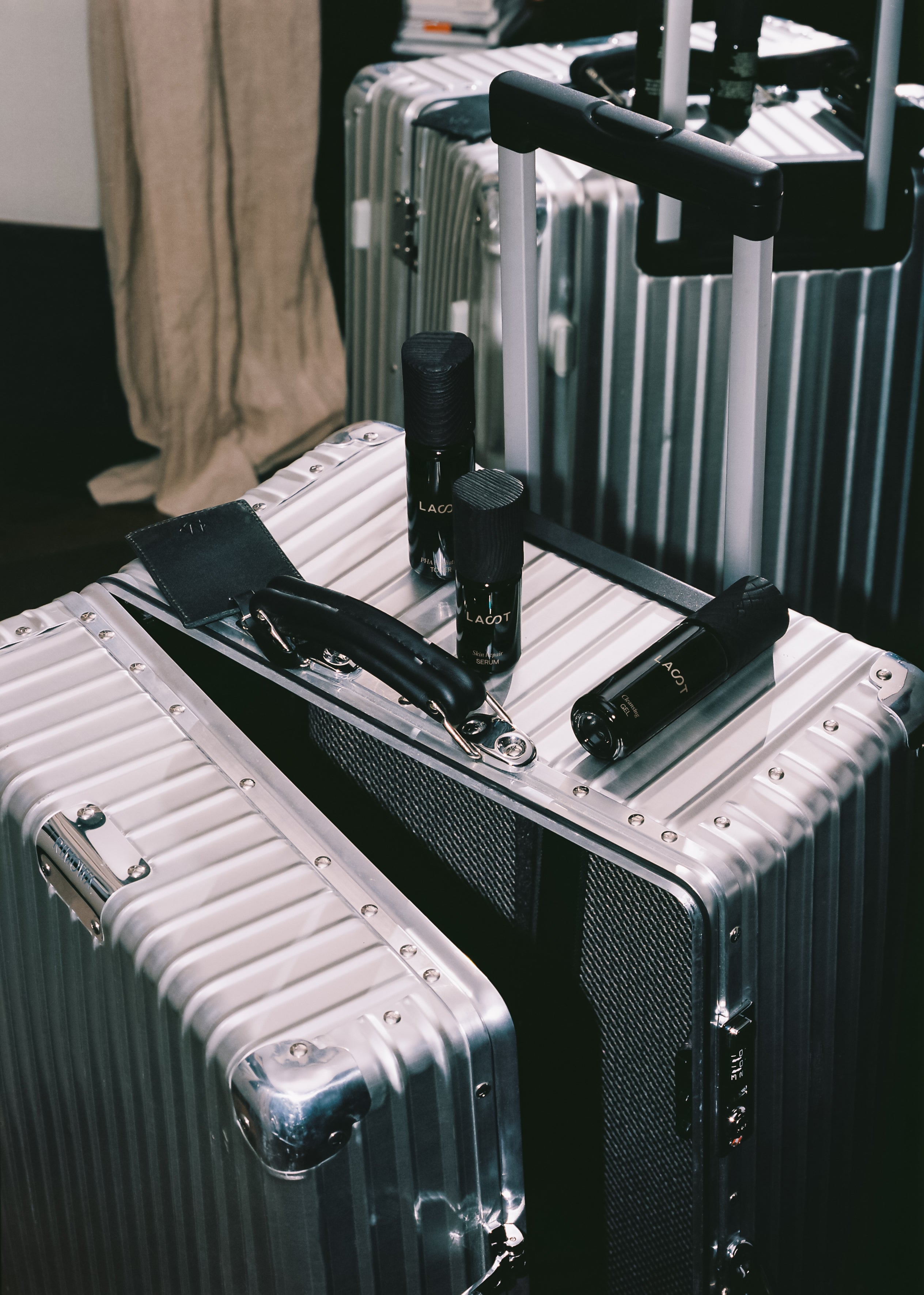 LAST skincare bottles on Rimowa luggage