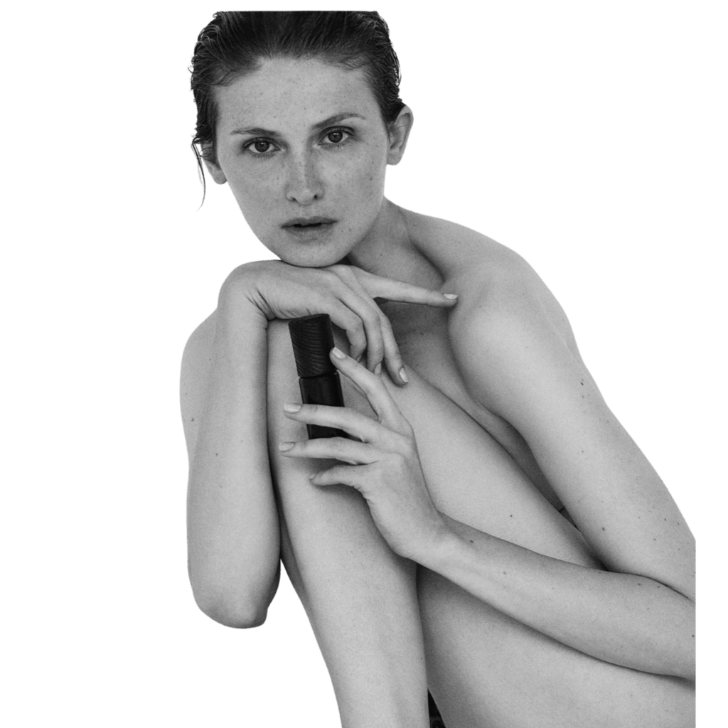 Woman holding a bottle of LAST skincare product on a transparent background