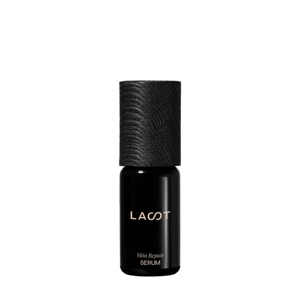 Black violet glass bottle of LAST Skin Repair Serum with LAST branding on a white background