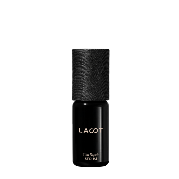 Black violet glass bottle of LAST Skin Repair Serum with LAST branding on a white background